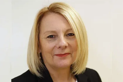 a woman with blonde hair wearing a black jacket